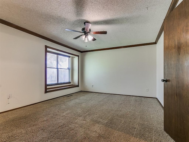 carpeted empty room with ceiling fan, crown molding, and a textured ceiling