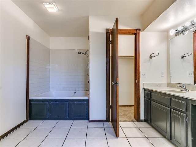 bathroom featuring tile patterned floors, vanity, and tiled shower / bath