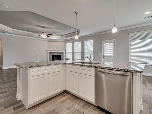 kitchen featuring white cabinetry, pendant lighting, and stainless steel dishwasher