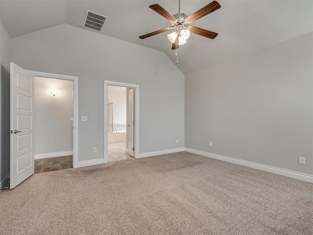 unfurnished bedroom featuring ceiling fan, light colored carpet, and vaulted ceiling