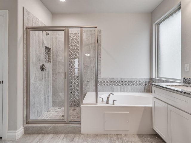 bathroom with tile patterned floors, vanity, and plus walk in shower