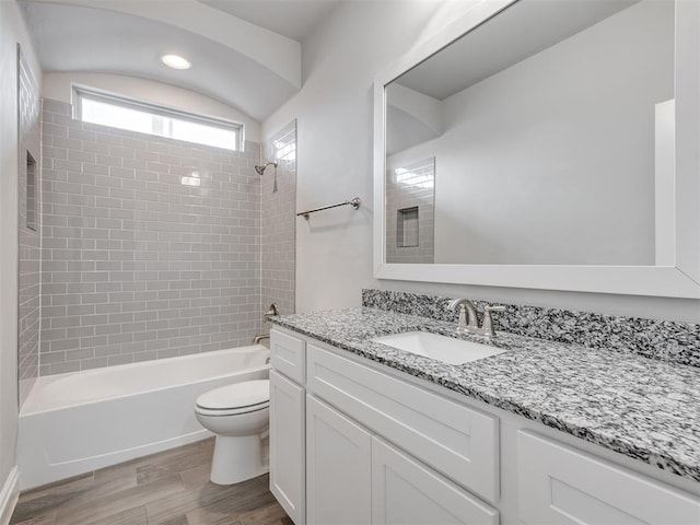 full bathroom with vanity, toilet, and tiled shower / bath combo