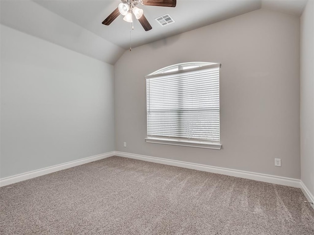 spare room featuring carpet flooring, plenty of natural light, and lofted ceiling