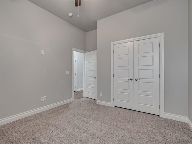 unfurnished bedroom with ceiling fan, a closet, and light colored carpet