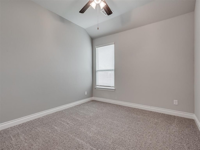 carpeted empty room featuring vaulted ceiling and ceiling fan