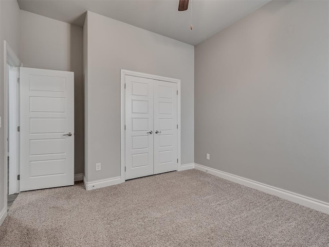 unfurnished bedroom with carpet flooring, a closet, and ceiling fan