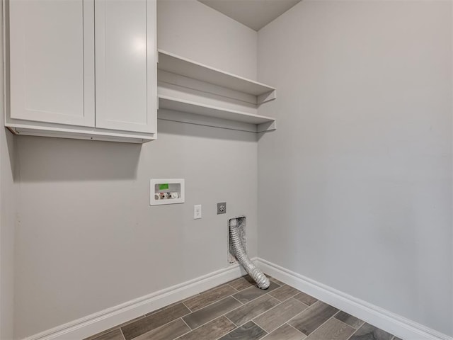 washroom with hookup for an electric dryer, washer hookup, and cabinets