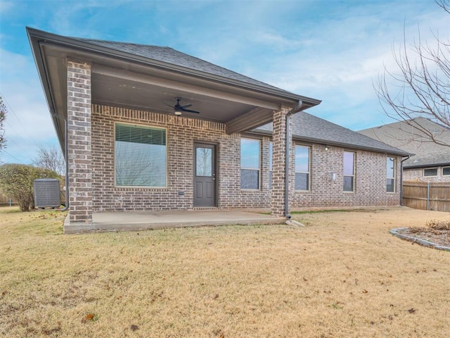 back of house featuring a lawn, ceiling fan, a patio area, and central AC