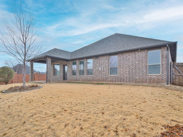 rear view of property featuring a yard