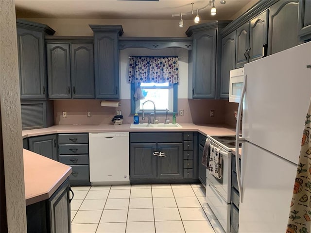 kitchen featuring light tile patterned floors, sink, and white appliances