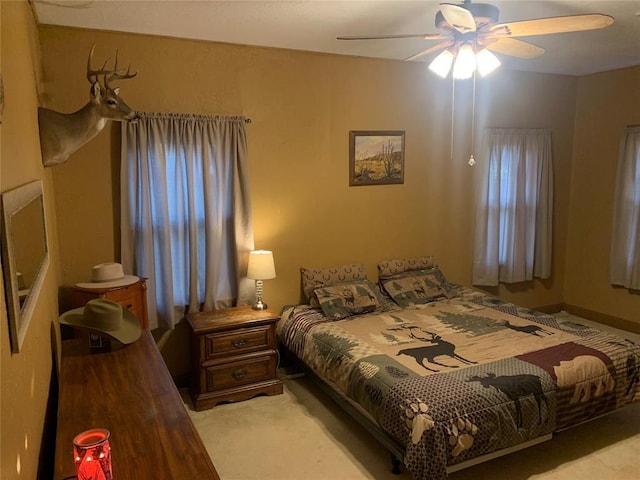 bedroom featuring ceiling fan and light colored carpet