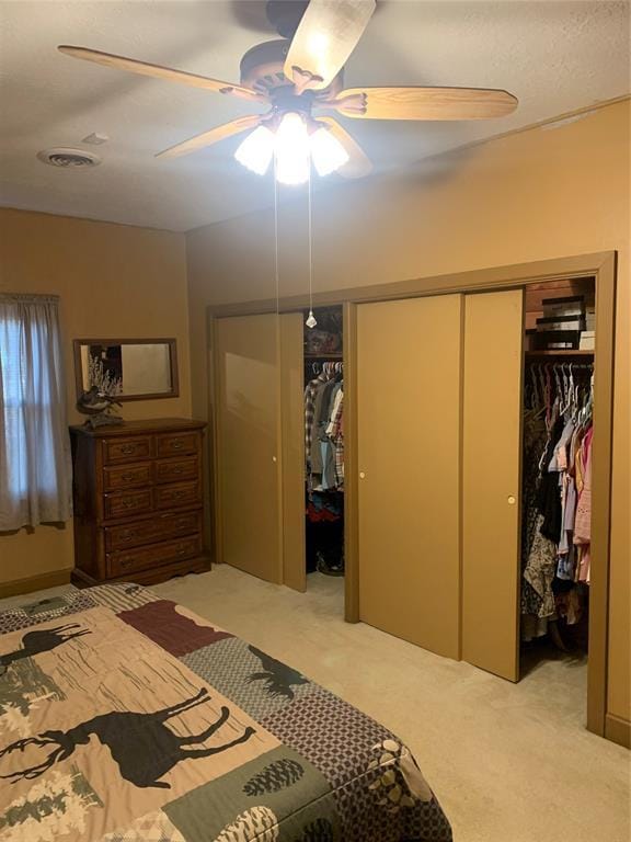 bedroom with ceiling fan and light carpet