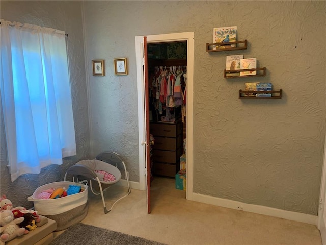 carpeted bedroom with a closet and a walk in closet