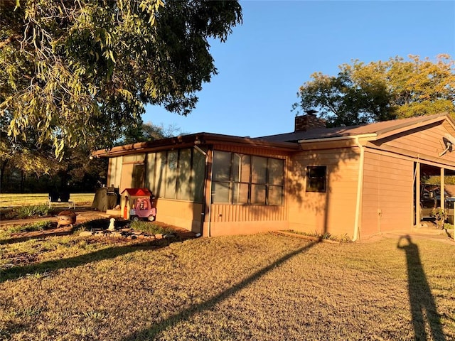 rear view of house with a lawn