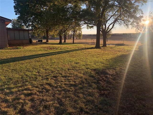 yard at dusk with a rural view