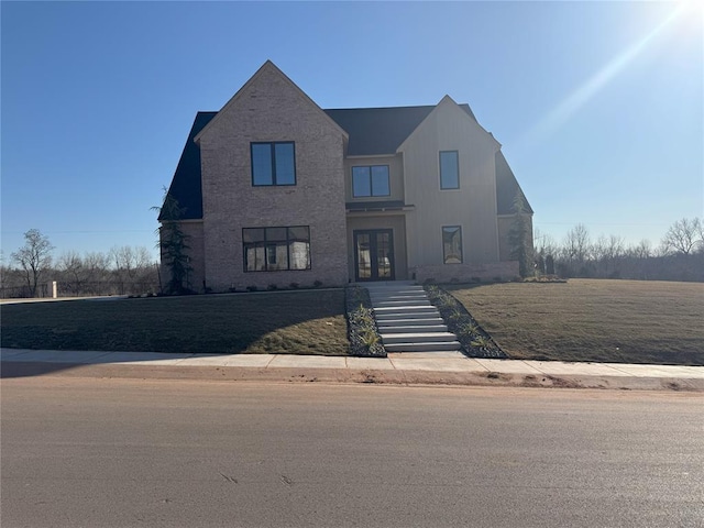 view of front of home with french doors and a front yard