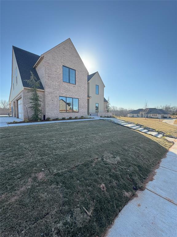 exterior space featuring a garage and a yard