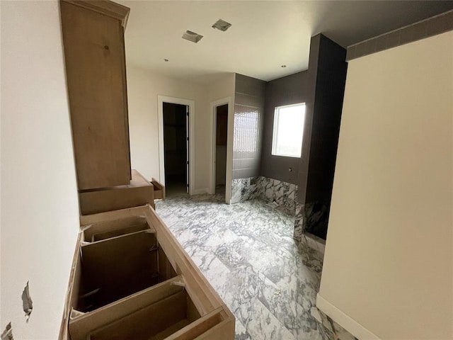 bathroom with marble finish floor and baseboards