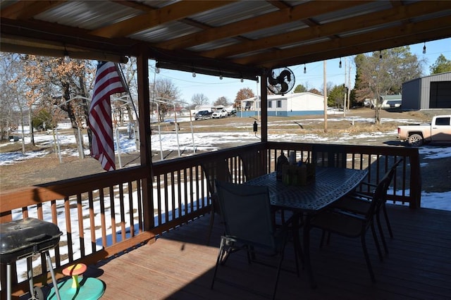 snow covered deck featuring a grill