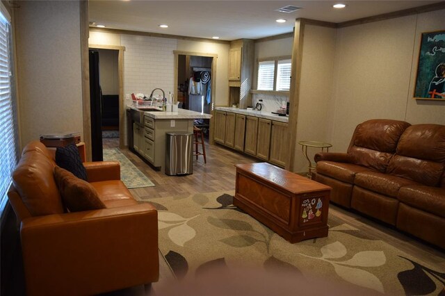 living room featuring wood finished floors, recessed lighting, and visible vents