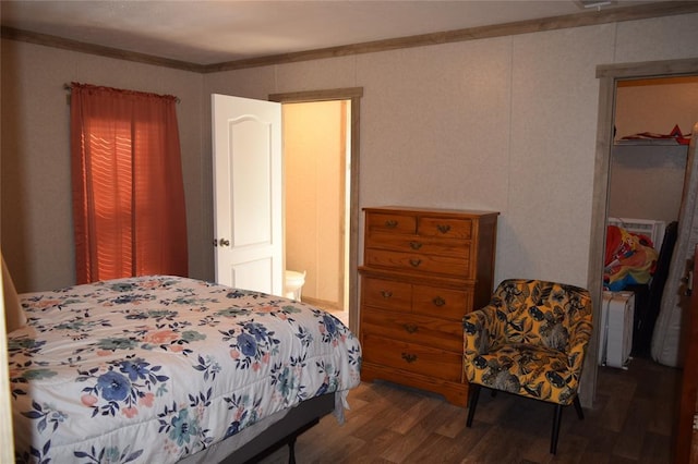 bedroom with crown molding and wood finished floors