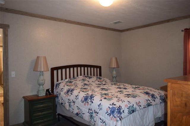 bedroom with ornamental molding and visible vents