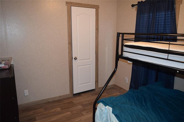 bedroom with wood finished floors