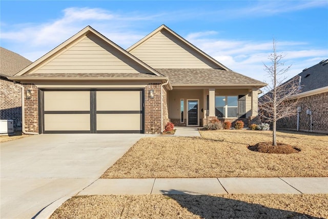 view of front of home featuring a garage, brick siding, driveway, and roof with shingles