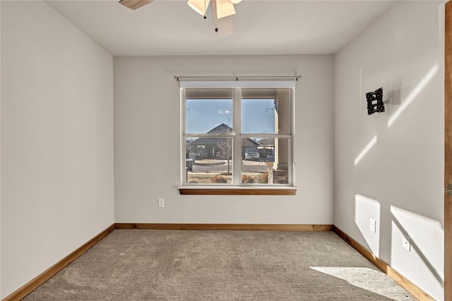 unfurnished room with light colored carpet and ceiling fan