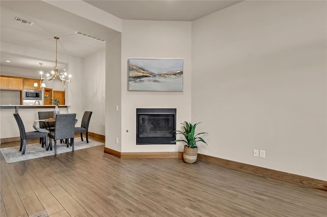 interior space featuring hardwood / wood-style floors and a notable chandelier