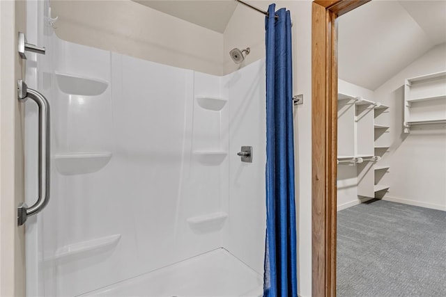 bathroom with a shower and vaulted ceiling