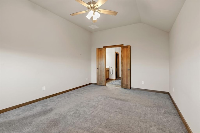 empty room featuring ceiling fan, carpet floors, and vaulted ceiling