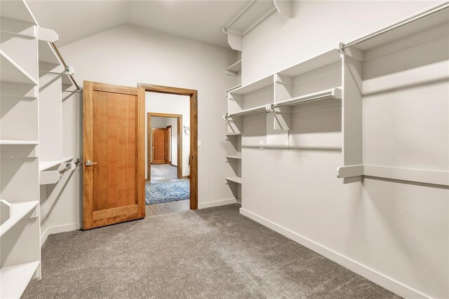 spacious closet with carpet and lofted ceiling