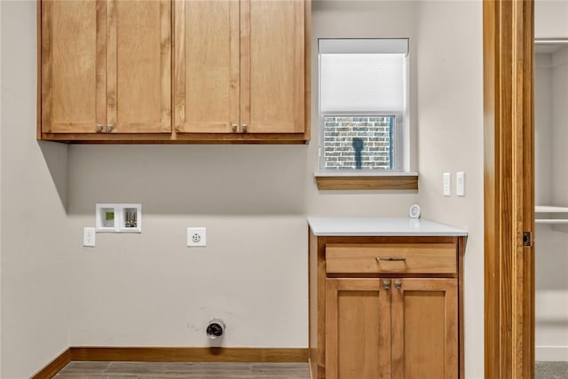 laundry area with hookup for an electric dryer, washer hookup, gas dryer hookup, and cabinets