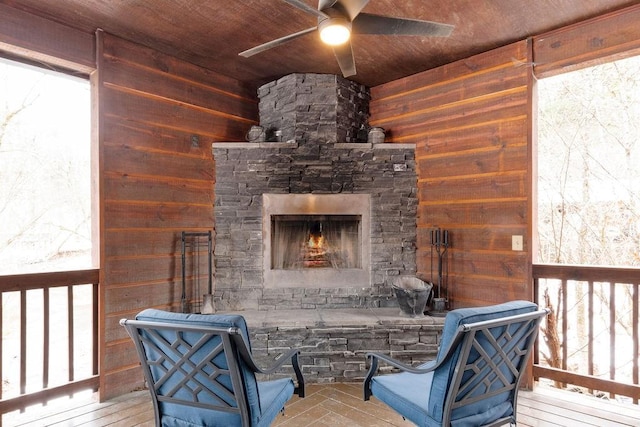 wooden terrace with ceiling fan and a fireplace