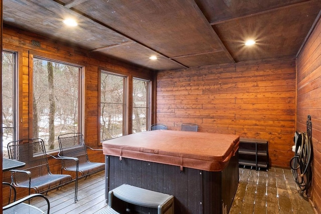 rec room with a hot tub, wood ceiling, wooden walls, and dark hardwood / wood-style floors