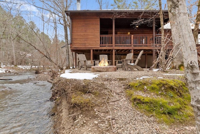 back of house with a fire pit