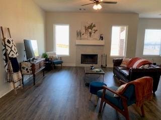 living room featuring ceiling fan and dark hardwood / wood-style floors