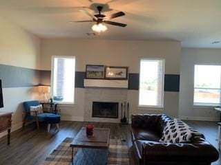 living room featuring ceiling fan and dark hardwood / wood-style floors