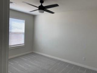 spare room featuring carpet flooring and plenty of natural light