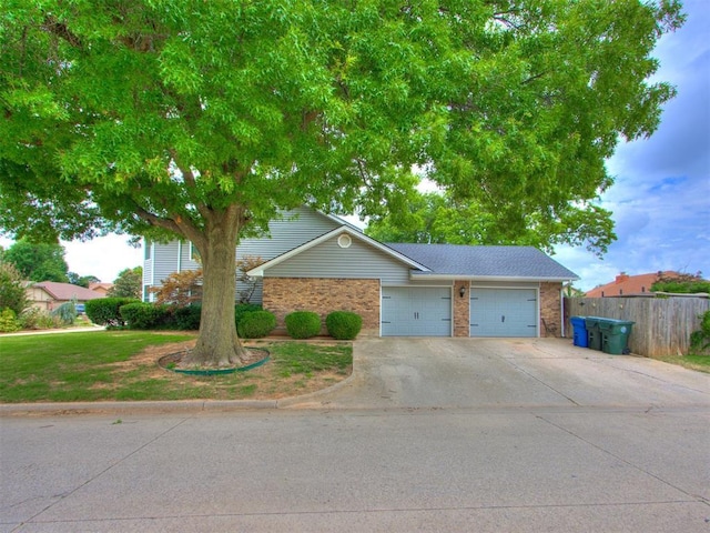 view of front of home with a front lawn and a garage