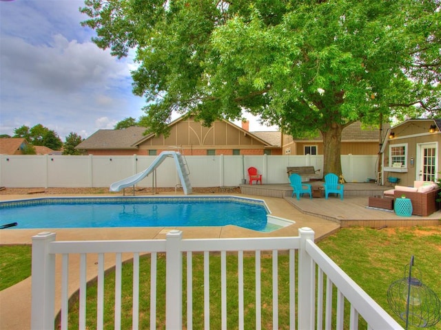 view of pool featuring a yard and a water slide