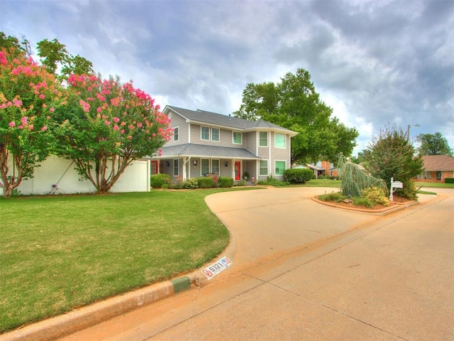 view of front facade with a front lawn and a porch