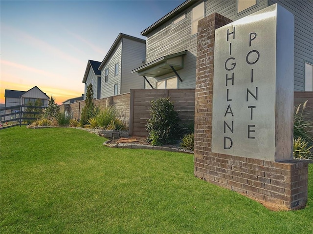 community sign featuring a lawn