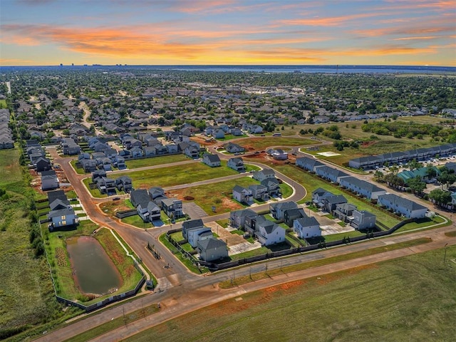 aerial view at dusk featuring a residential view