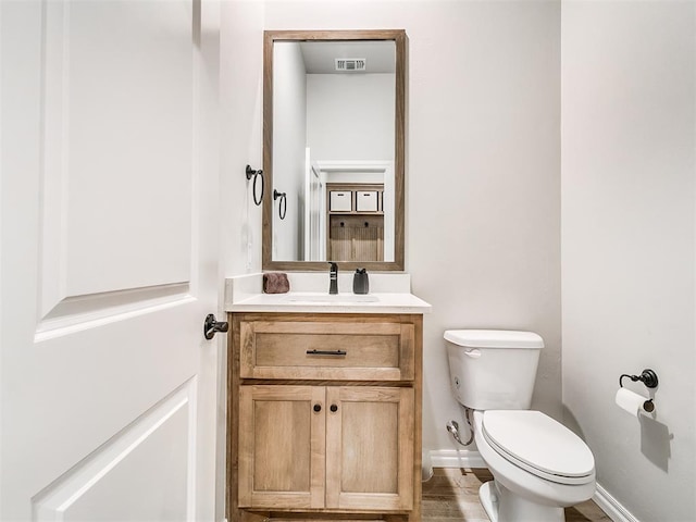 bathroom featuring toilet and vanity