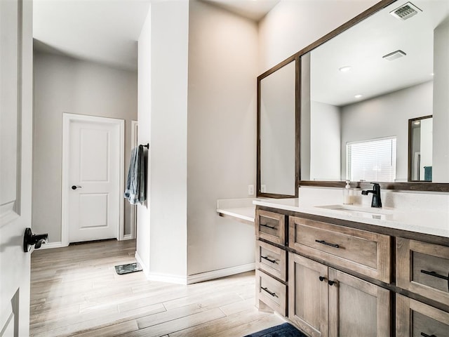 bathroom featuring vanity and hardwood / wood-style floors