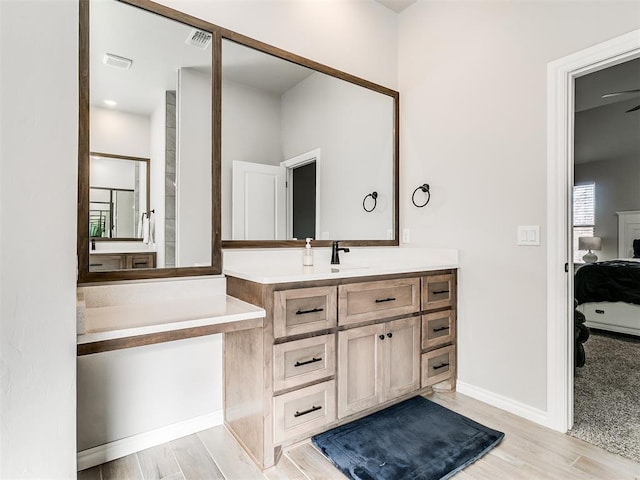 bathroom with ceiling fan and vanity