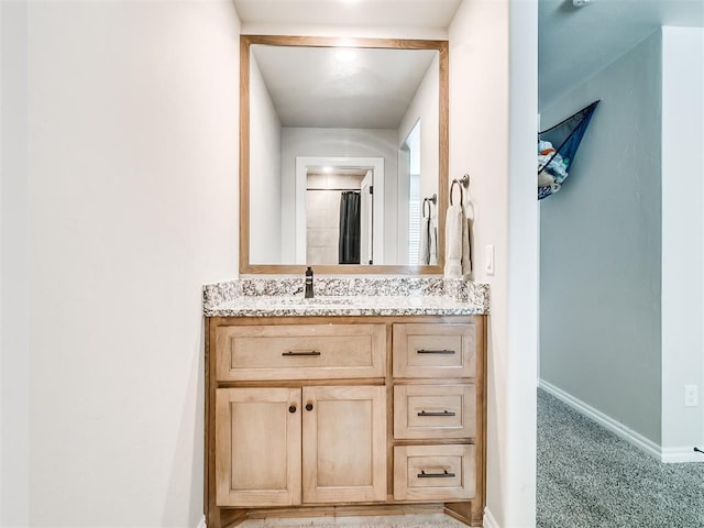 bathroom with curtained shower and vanity