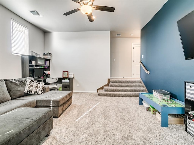 carpeted living room with ceiling fan